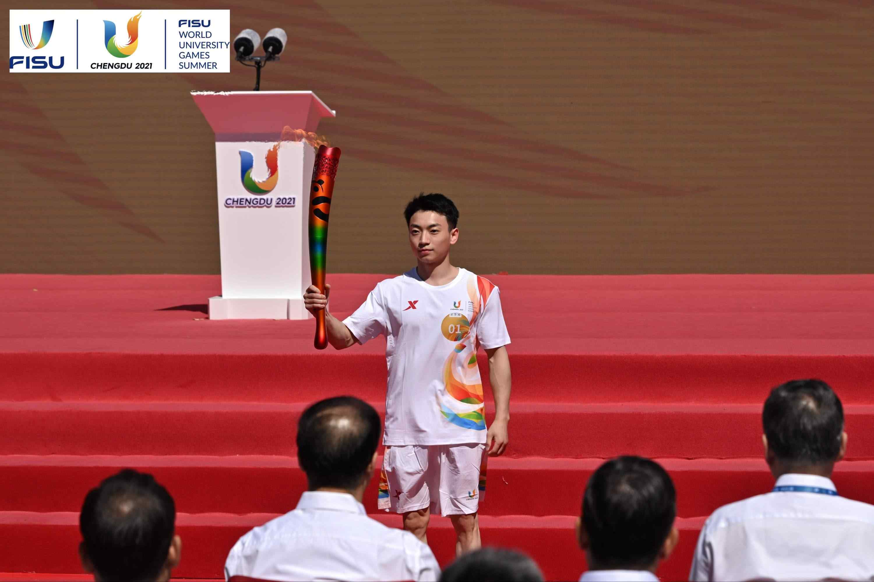 成都大運會火炬手、奧運冠軍鄒敬園高舉火炬。 圖片來源：成都大運會執(zhí)委會供圖