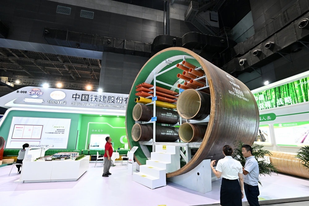 9月2日，在國(guó)家體育館舉行的服貿(mào)會(huì)環(huán)境服務(wù)專(zhuān)題展上，客商在中國(guó)鐵建展位竹纏繞管廊旁了解信息。新華社記者 李鑫 攝