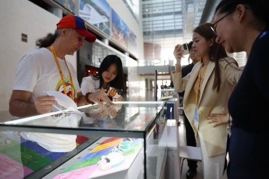 10月16日，參會(huì)記者在“一帶一路”國(guó)際合作高峰論壇新聞中心參觀展示的中國(guó)非物質(zhì)文化遺產(chǎn)展品。新華社記者 陳斌 攝