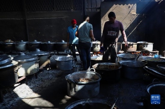 11月3日，在加沙地帶南部城市拉法，人們?cè)诿簹庵袛嗪笥貌窕鹱鲲?。新華社發(fā)（里澤克·阿卜杜勒賈瓦德攝）