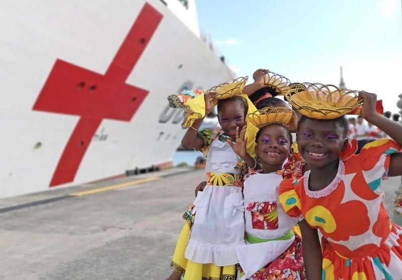 2018年10月，在安提瓜和巴布達(dá)首都圣約翰，當(dāng)?shù)匦∨笥焉泶﹤鹘y(tǒng)服裝歡迎中國海軍“和平方舟”醫(yī)院船首次到訪。