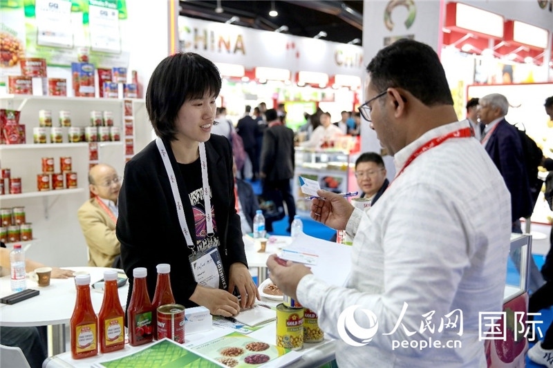 圖為中國參展企業(yè)代表與采購商交流。人民網(wǎng) 塔里克·易卜拉欣攝