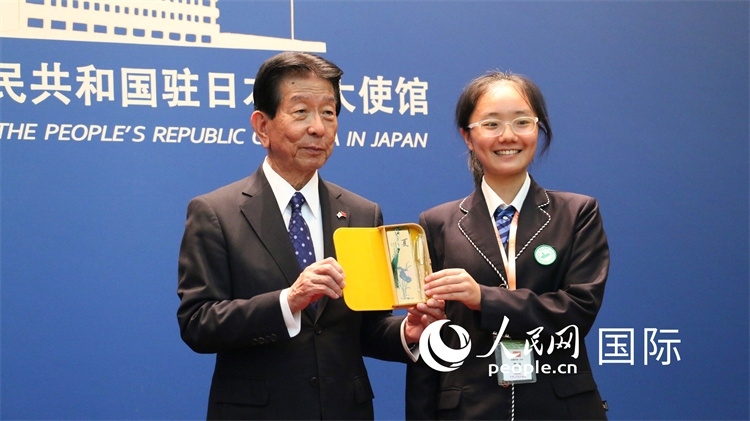 中國(guó)小大使向日本永旺1%俱樂部理事長(zhǎng)森美樹贈(zèng)送當(dāng)?shù)靥厣Y品。人民網(wǎng) 許可攝