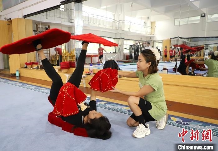 9月13日，來自老撾的紅姆(右)指導(dǎo)學(xué)員雜技動作。 馬天龍 攝