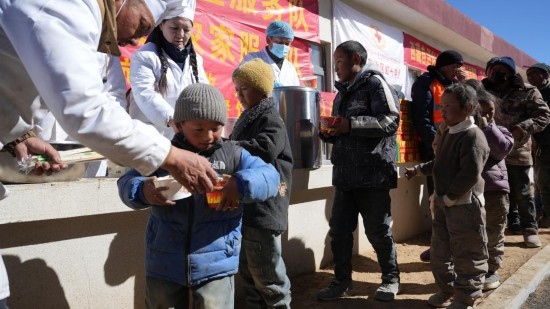 1月14日，廚師們正在給前來用餐的小朋友們打飯。新華社記者 邱星翔 攝