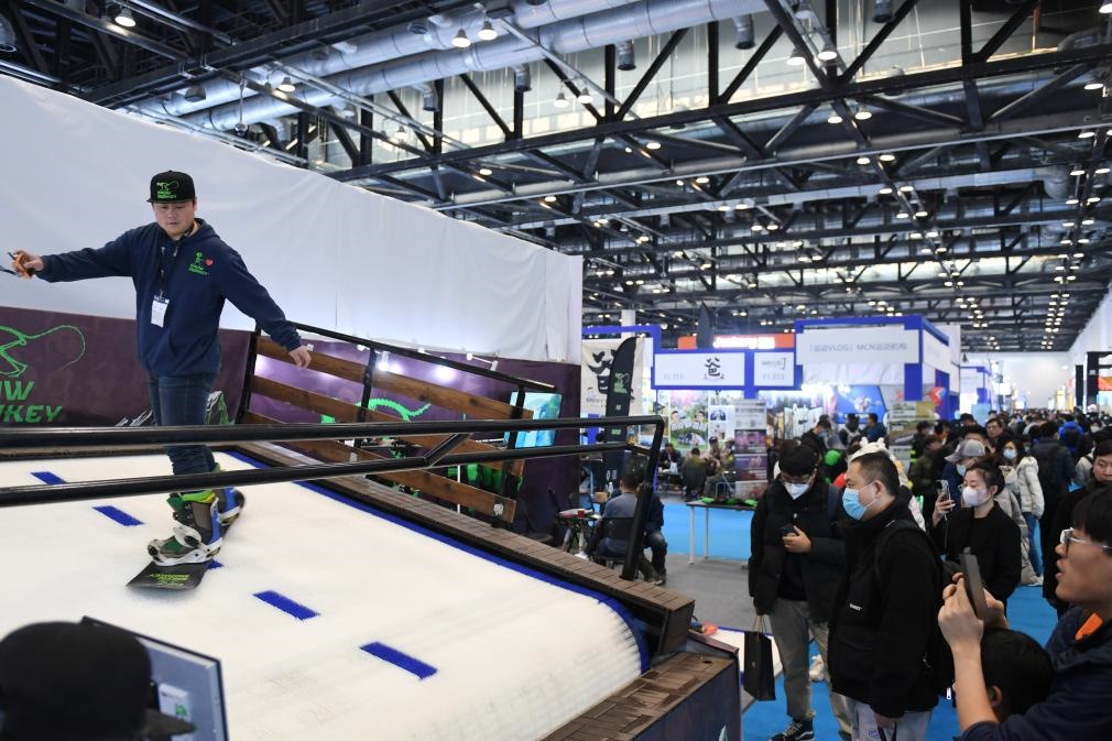 2023年2月11日，參觀者在展會(huì)上了解一款模擬滑雪設(shè)備。當(dāng)日，2023亞洲運(yùn)動(dòng)用品與時(shí)尚展在國(guó)家會(huì)議中心拉開(kāi)帷幕。新華社記者 張晨霖 攝