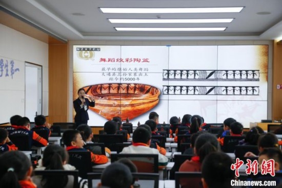 圖為學(xué)生在“國寶音樂會(huì)”社教課中了解舞蹈紋彩陶盆。中新社記者 馬銘言 攝