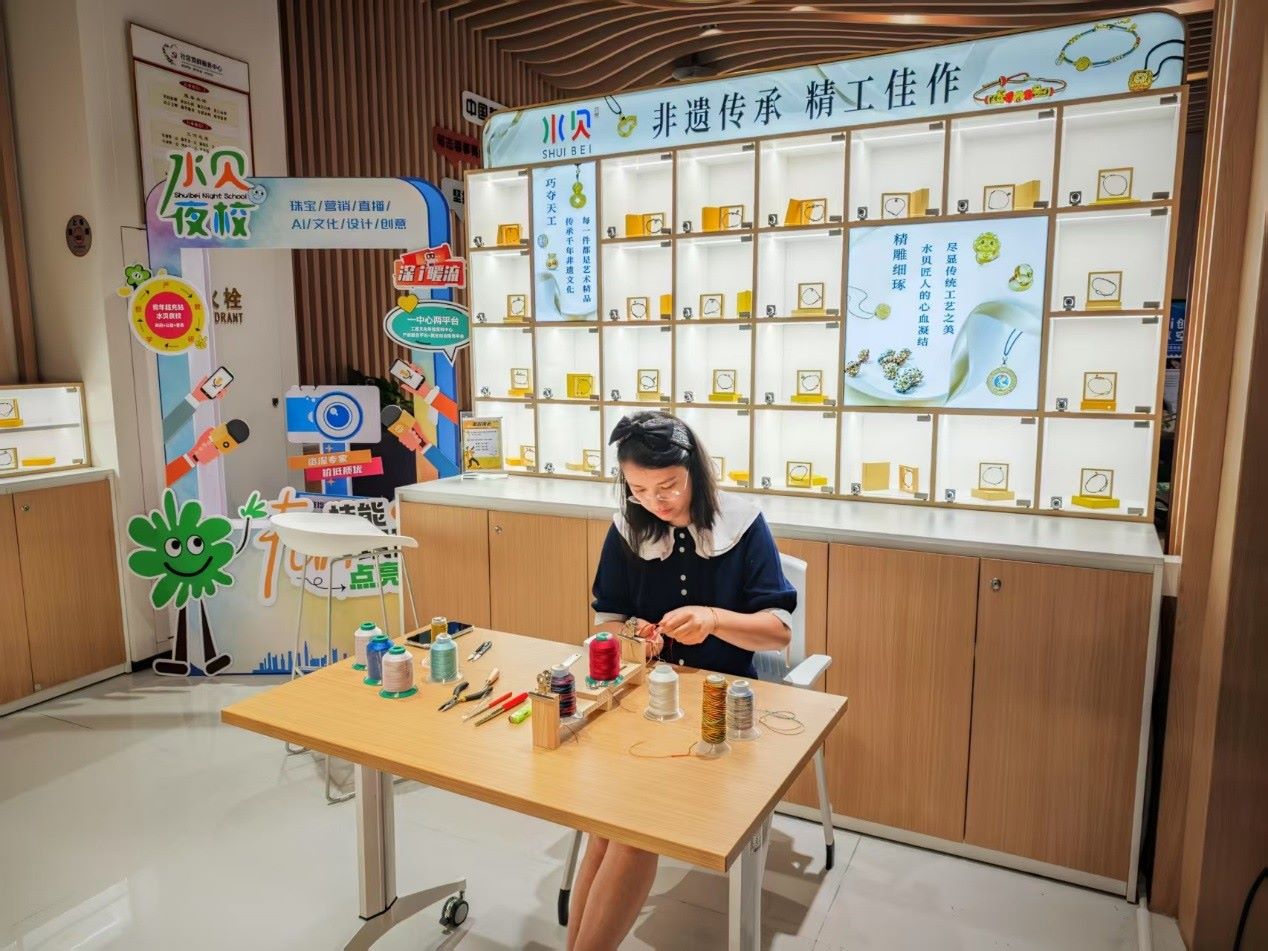 水貝夜校學(xué)員正在展示手工編繩過程。人民網(wǎng) 肖聰聰攝