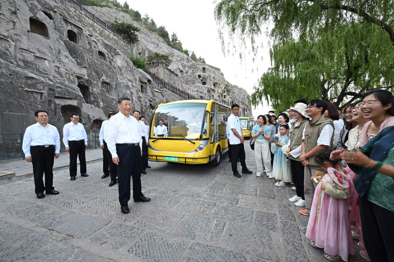 5月19日，習(xí)近平在洛陽龍門石窟考察時(shí)，同游客親切交流。